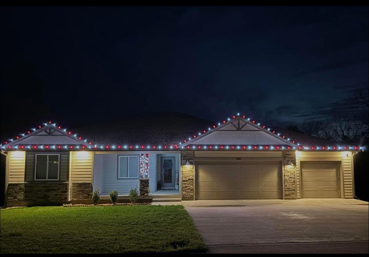 Christmas light installation on a red and white ranch home in Lawrence, Kansas by First Response Exterior Lights