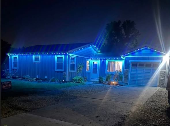 Permanent Christmas lights on a single-story ranch home in Lawrence, Kansas by First Response Exterior Lights